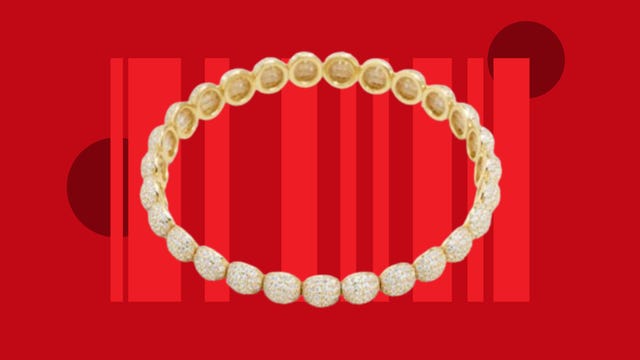 The Yuki 18K gold bracelet from Baublebar is displayed against a red background.