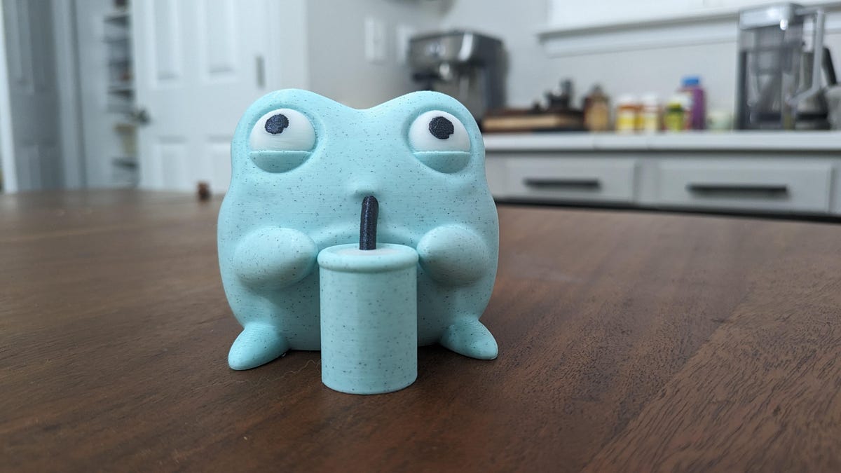 A cute 3D printed frog drinking a milkshake