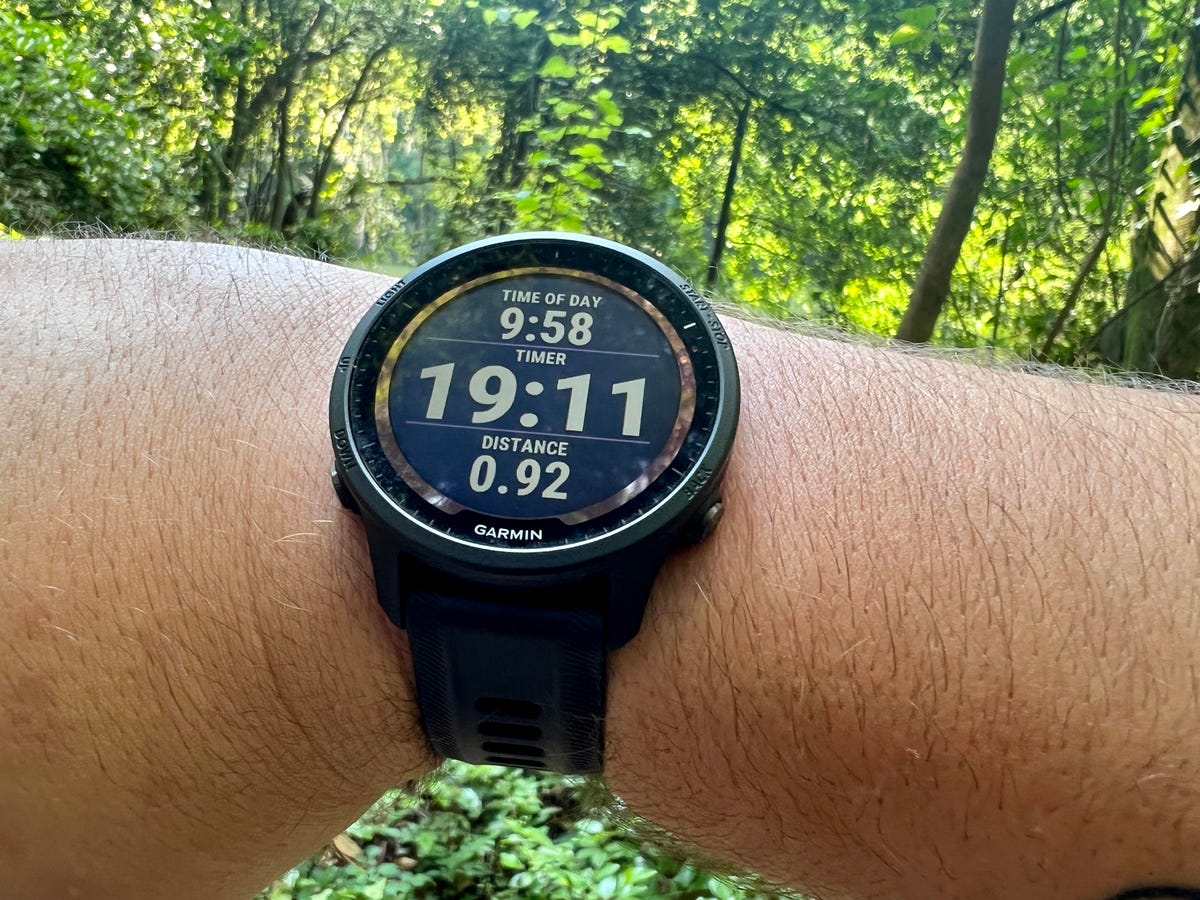Garmin Forerunner 955 Fitness watch tracking a walk in the woods