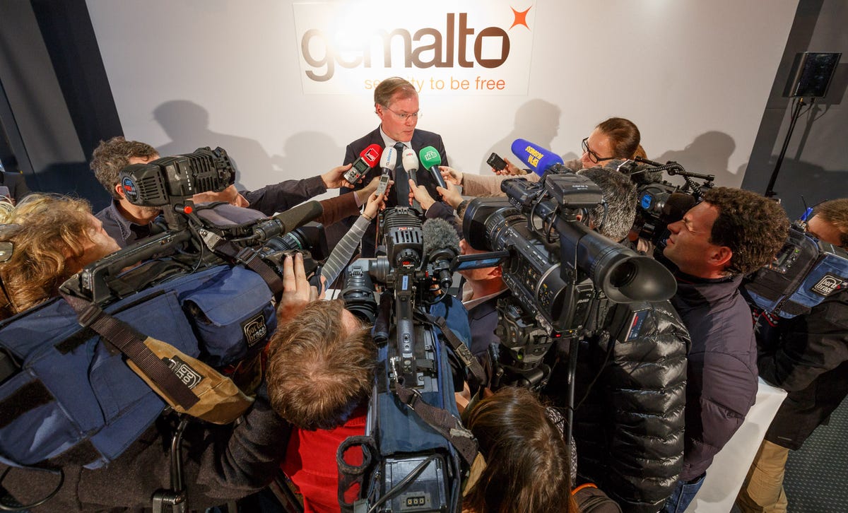 Gemalto Chief Executive Olivier Piou answers questions about SIM card key theft attempts at a Paris news conference.