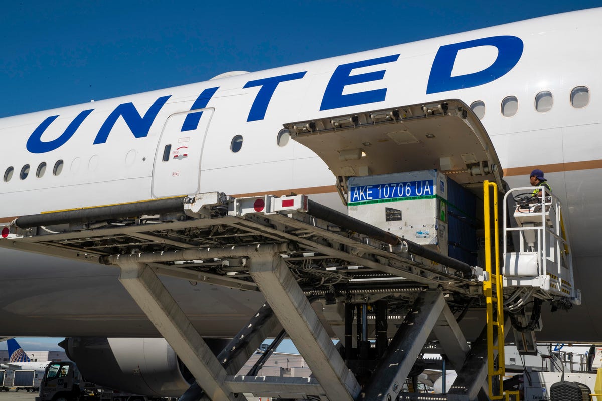 Baggage containers get loaded into a United Airlines Boeing 777.