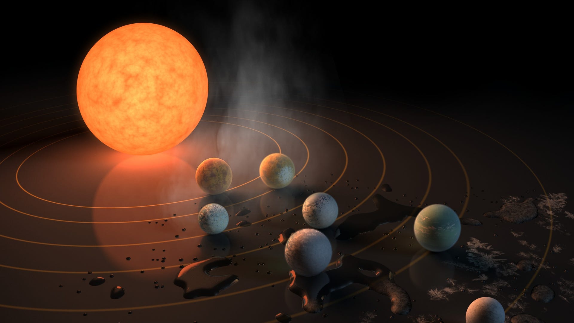 Stylized illustration shows an orange star with seven Earth-sized planets around it in orbit.