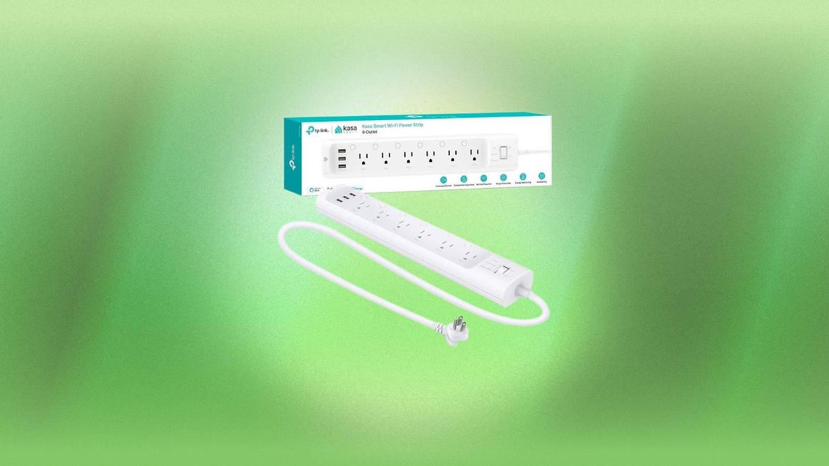 A white power strip and box against a green background.