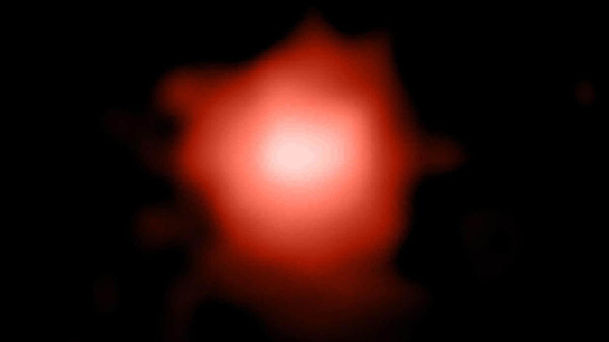 an amorphous red stain against the void of space