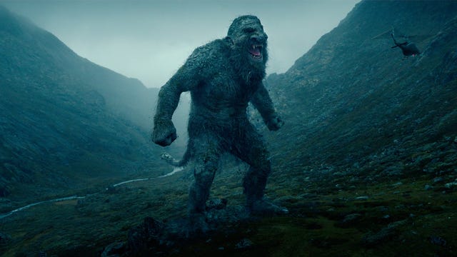 A giant troll standing in a misty valley