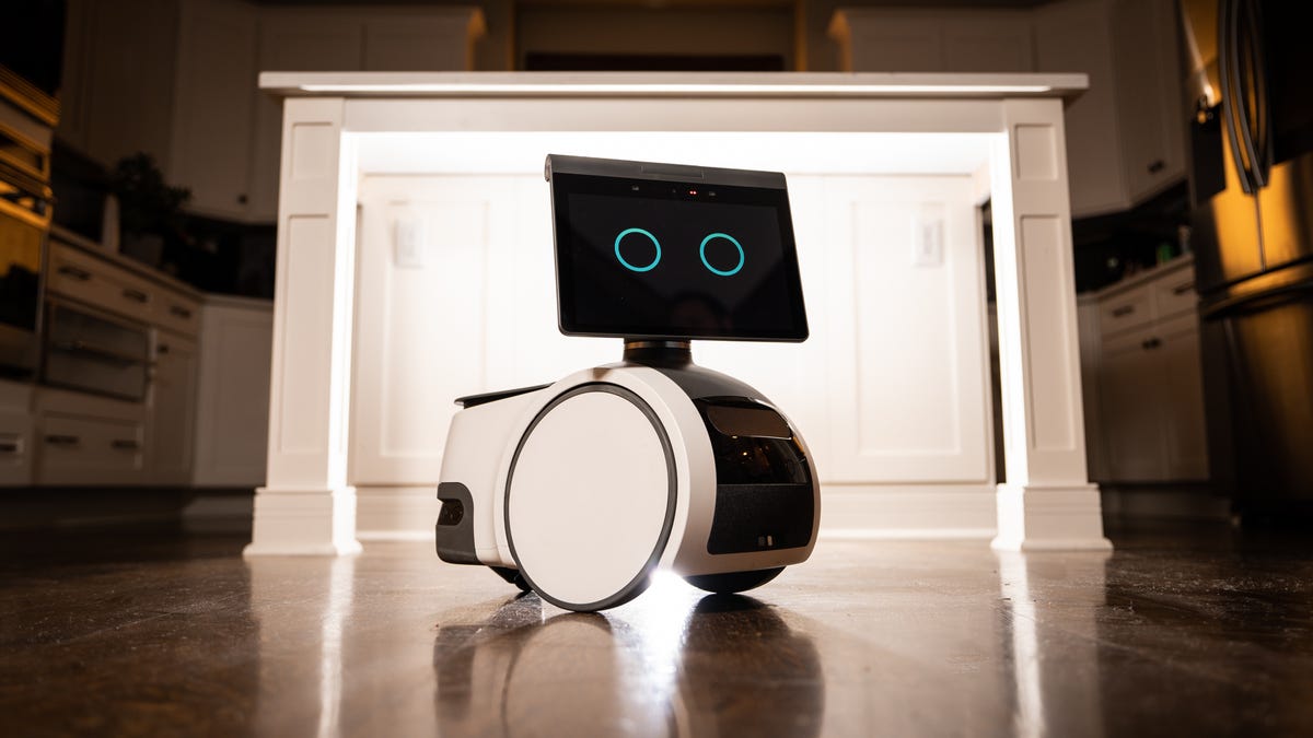 Amazon's Astro robot in front of a kitchen island, beautifully backlit