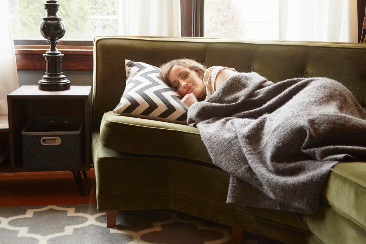 Woman sleeping on her side on the living room couch