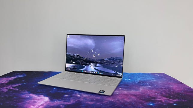 Dell XPS 13 Plus at a angle against a gray background
