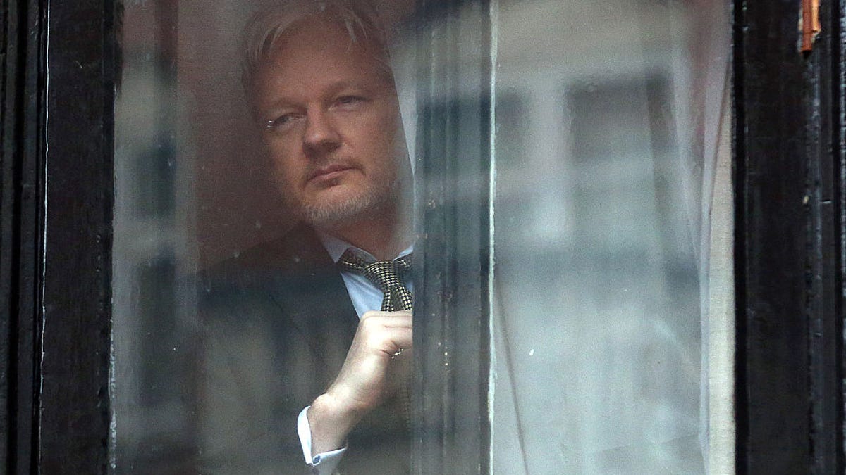 WikiLeaks founder Julian Assange prepares to speak from the balcony of the Ecuadorian embassy, where he's lived since 2012.
