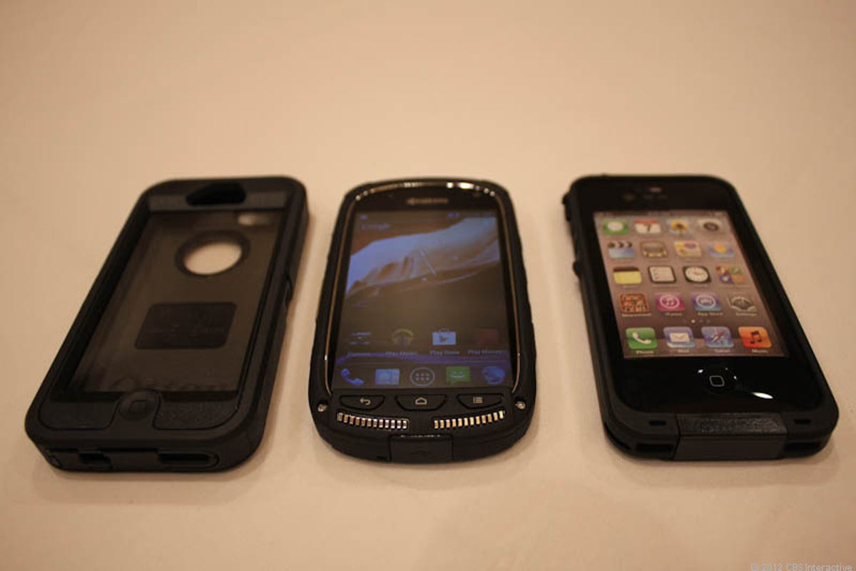 Kyocera Torque next to Otterbox and LifeProof iPhone cases