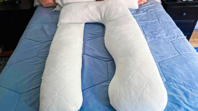Newton Baby Pregnancy Pillow on a bed