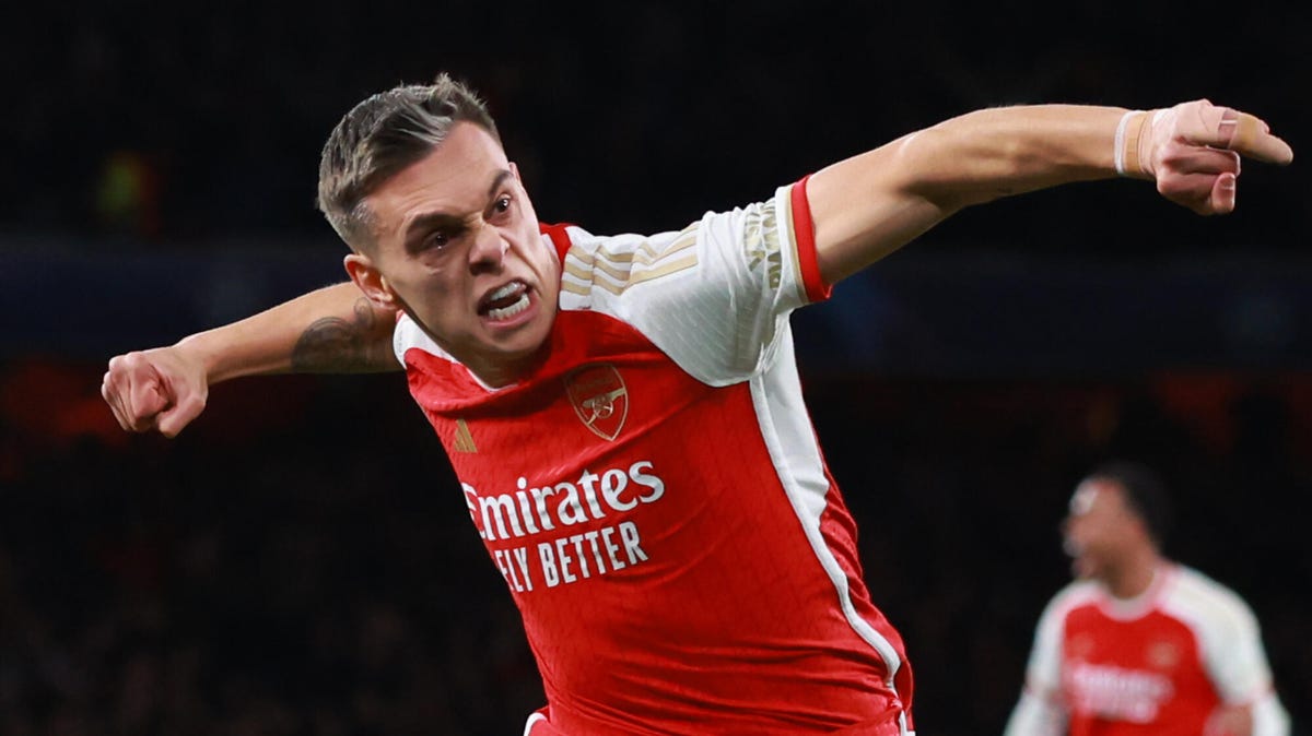 Leandro Trossard of Arsenal celebrating with both arms outstretched and his right fist clenched.