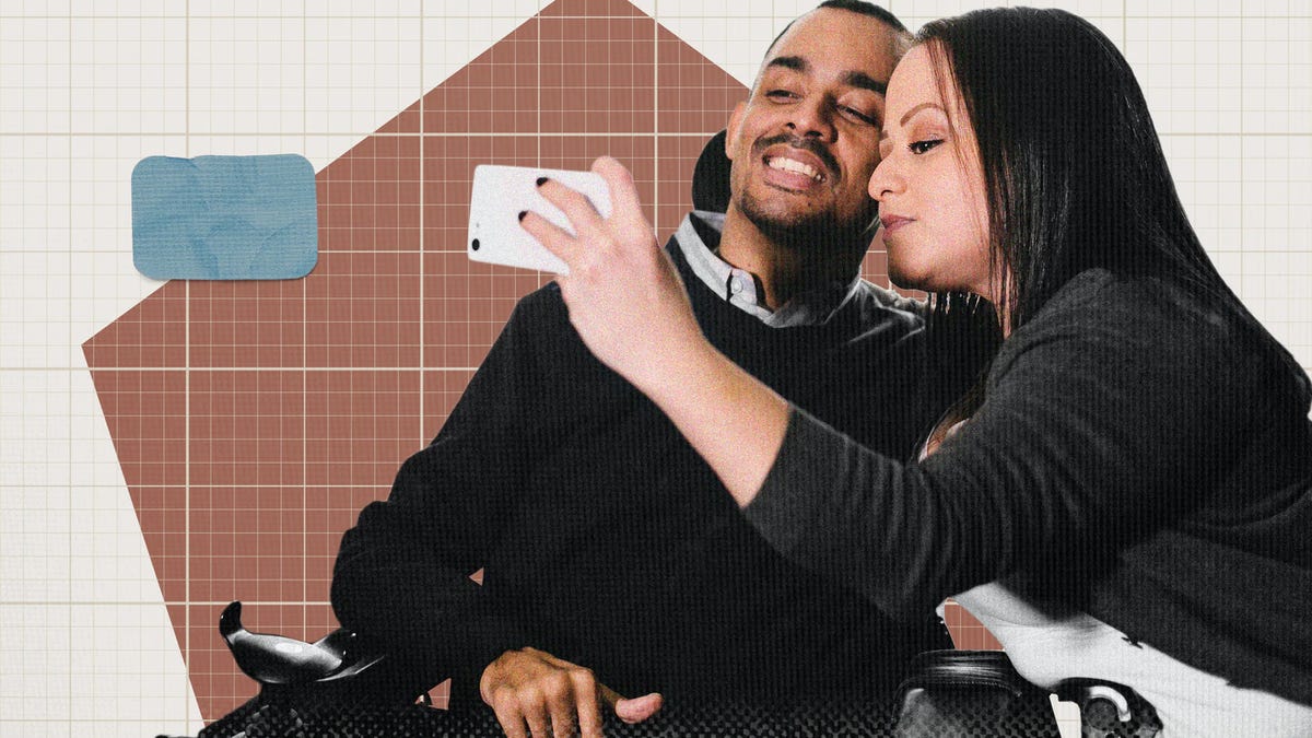 Two people with different skin tones taking a selfie with a phone.