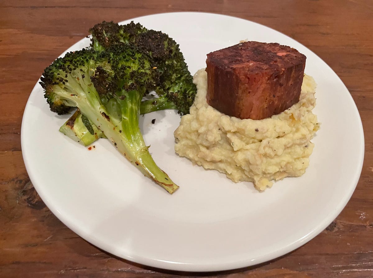 cooked steak on plate with mashed potatoes and broccoli