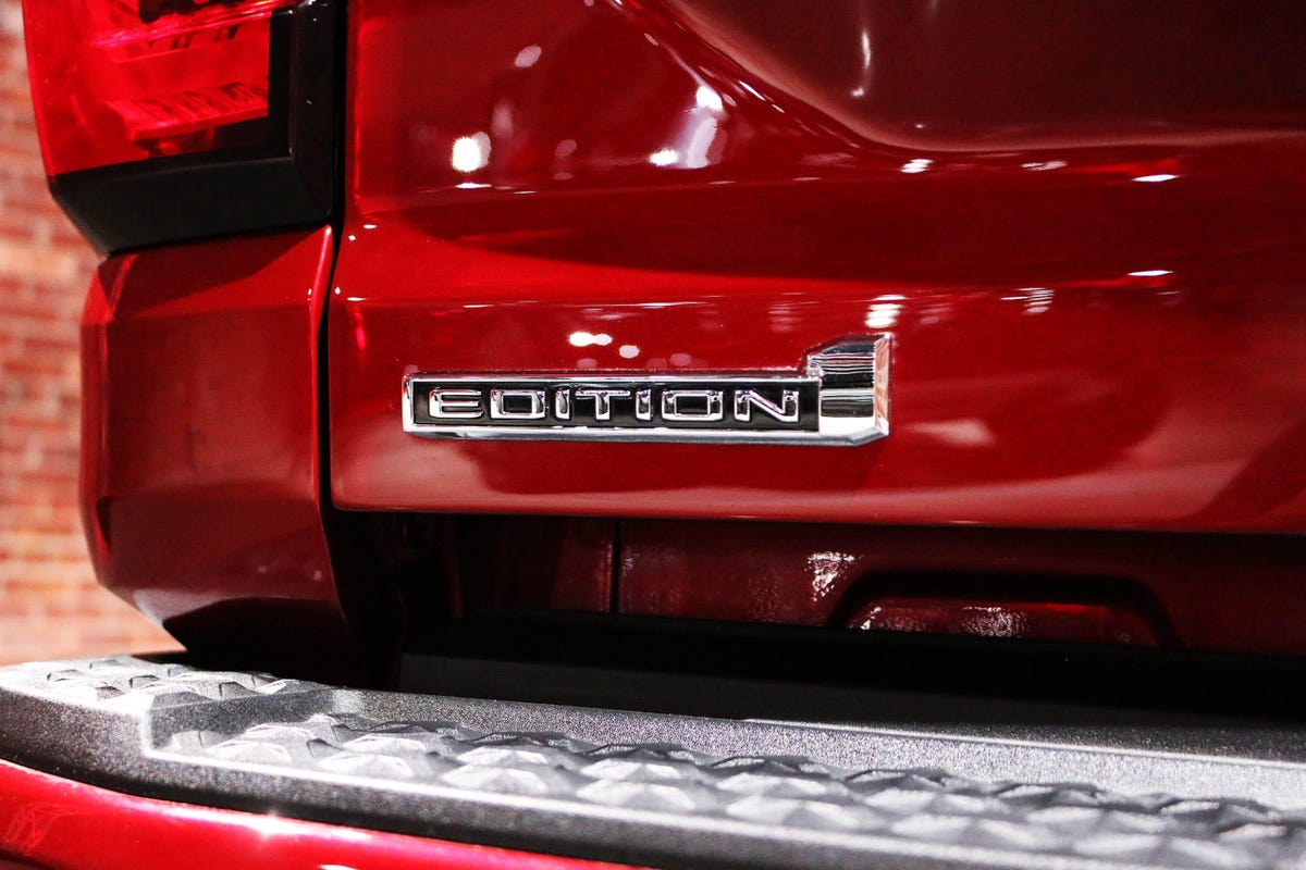 2023 GMC Canyon AT4X Edition 1 badge on a red truck in studio