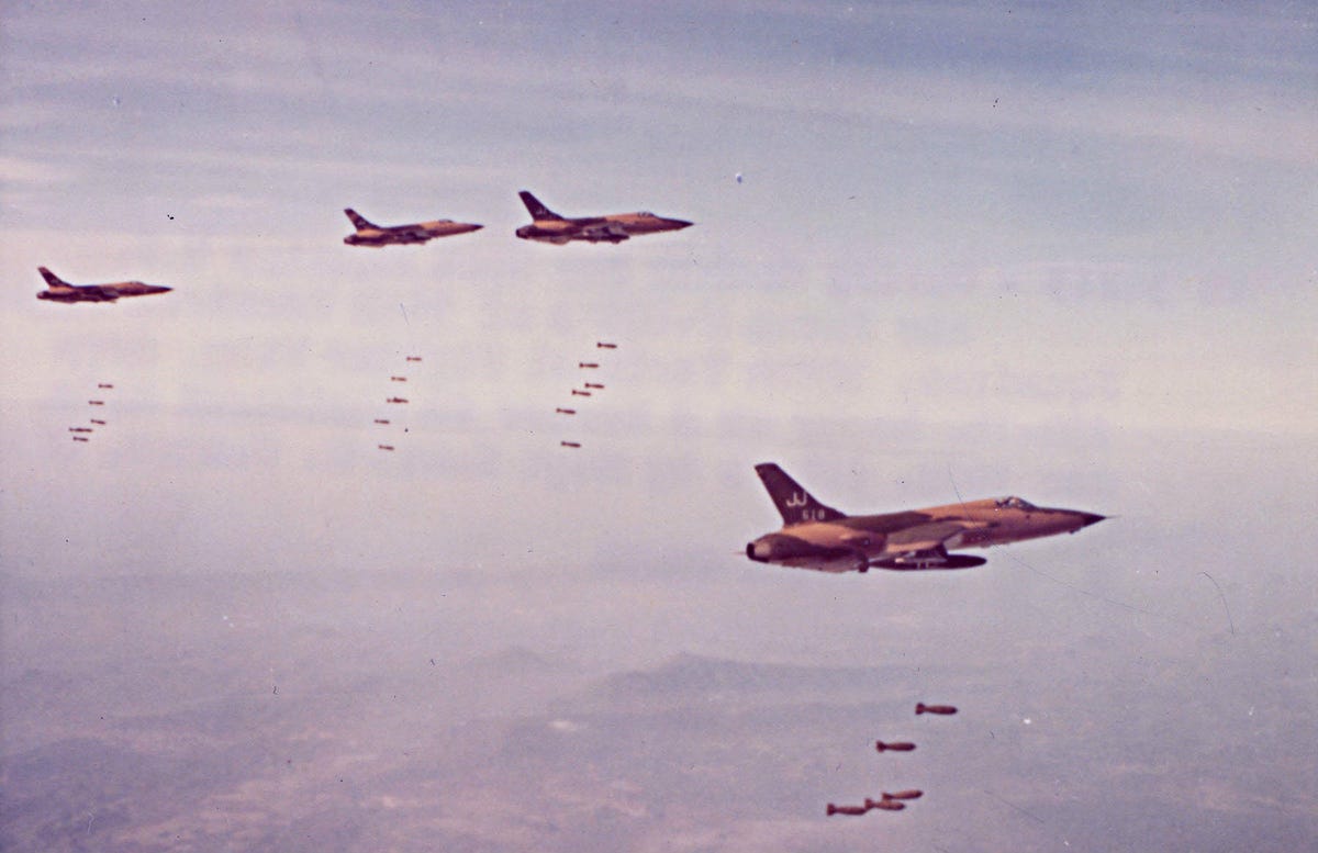 Four Republic F-105 Thunderchiefs dropping bombs