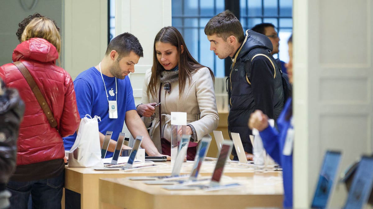 New customers check out the options at Apple's store in Paris.