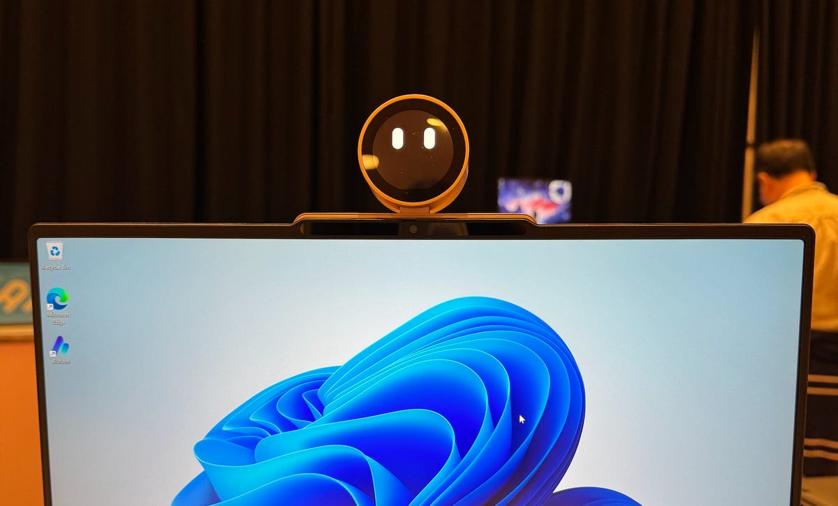 Lenovo's Magic Bay Robot, atop an open laptop screen