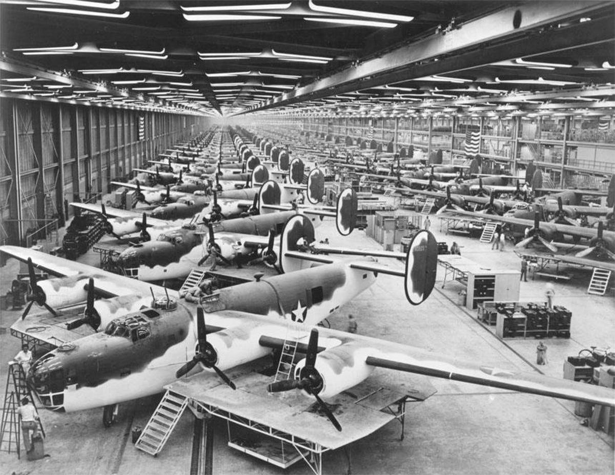 Dozens of B-24s lined up in a factory for assembly work