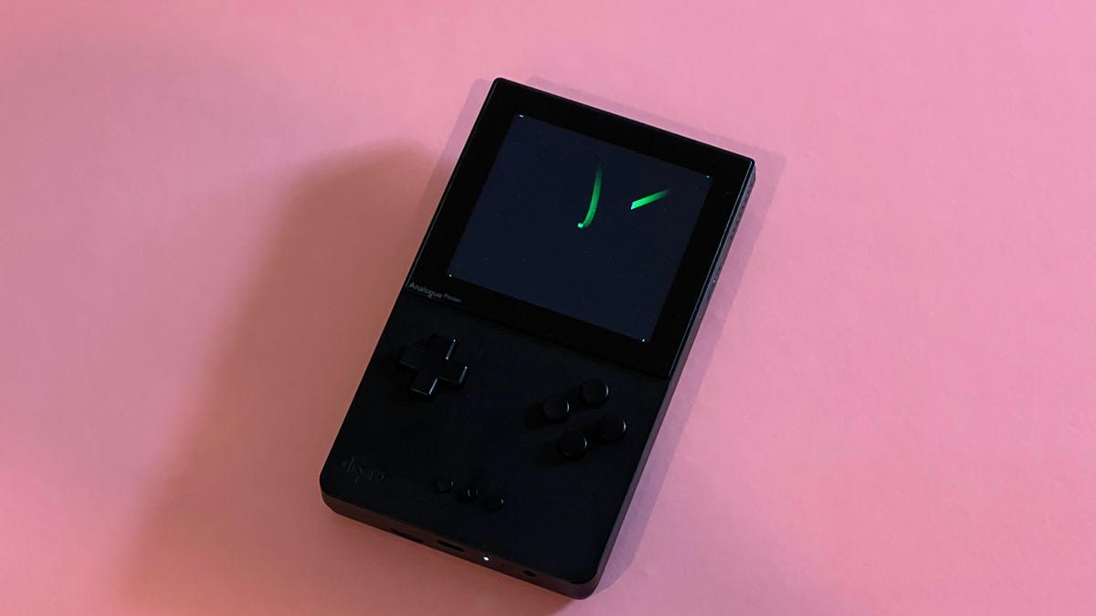 Analogue Pocket game handheld on a pink table