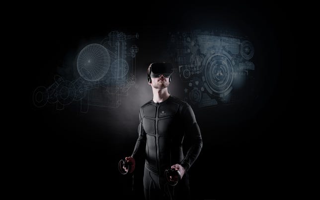 A man wears a VR headset and a technological bodysuit
