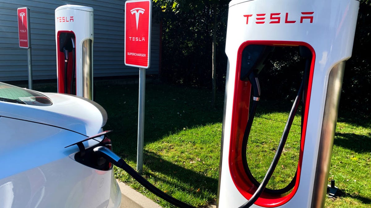 Car charging at Tesla Supercharger station