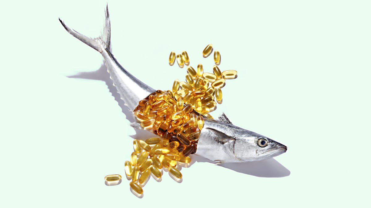 Omega-3 supplements bursting from a fresh fish