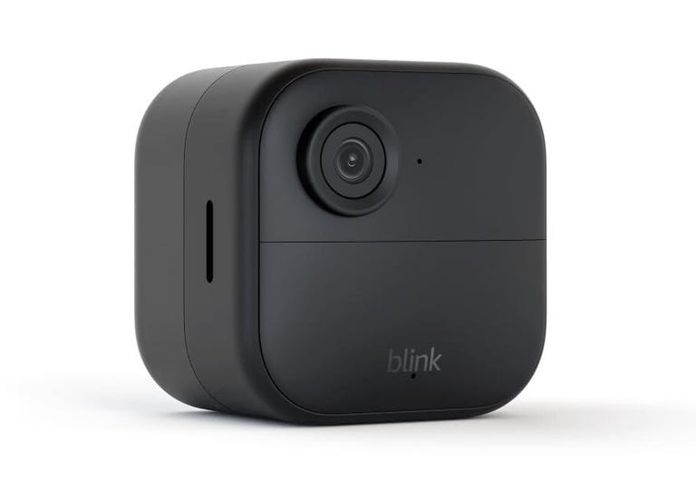 The Blink Outdoor 4 wireless camera with a battery extension pack attached.