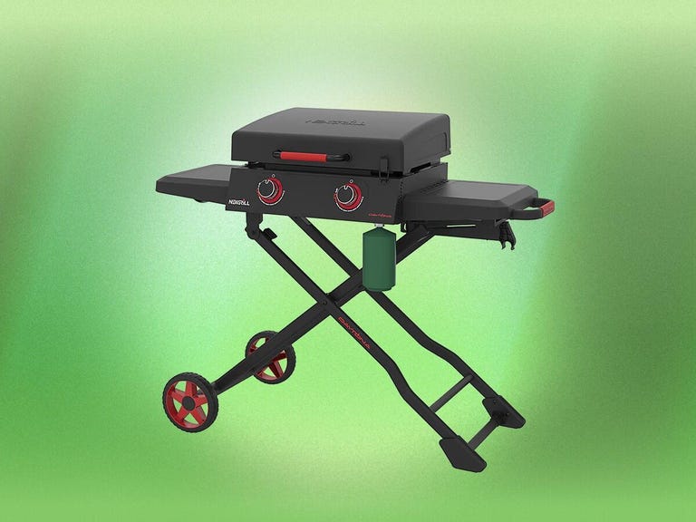 A foldable black griddle on a green background