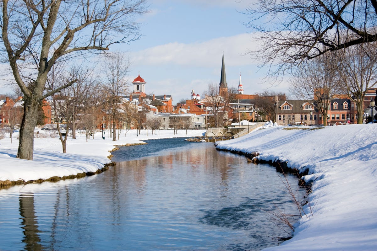 A view of Frederick, Maryland from the snow-covered banks of a creek.