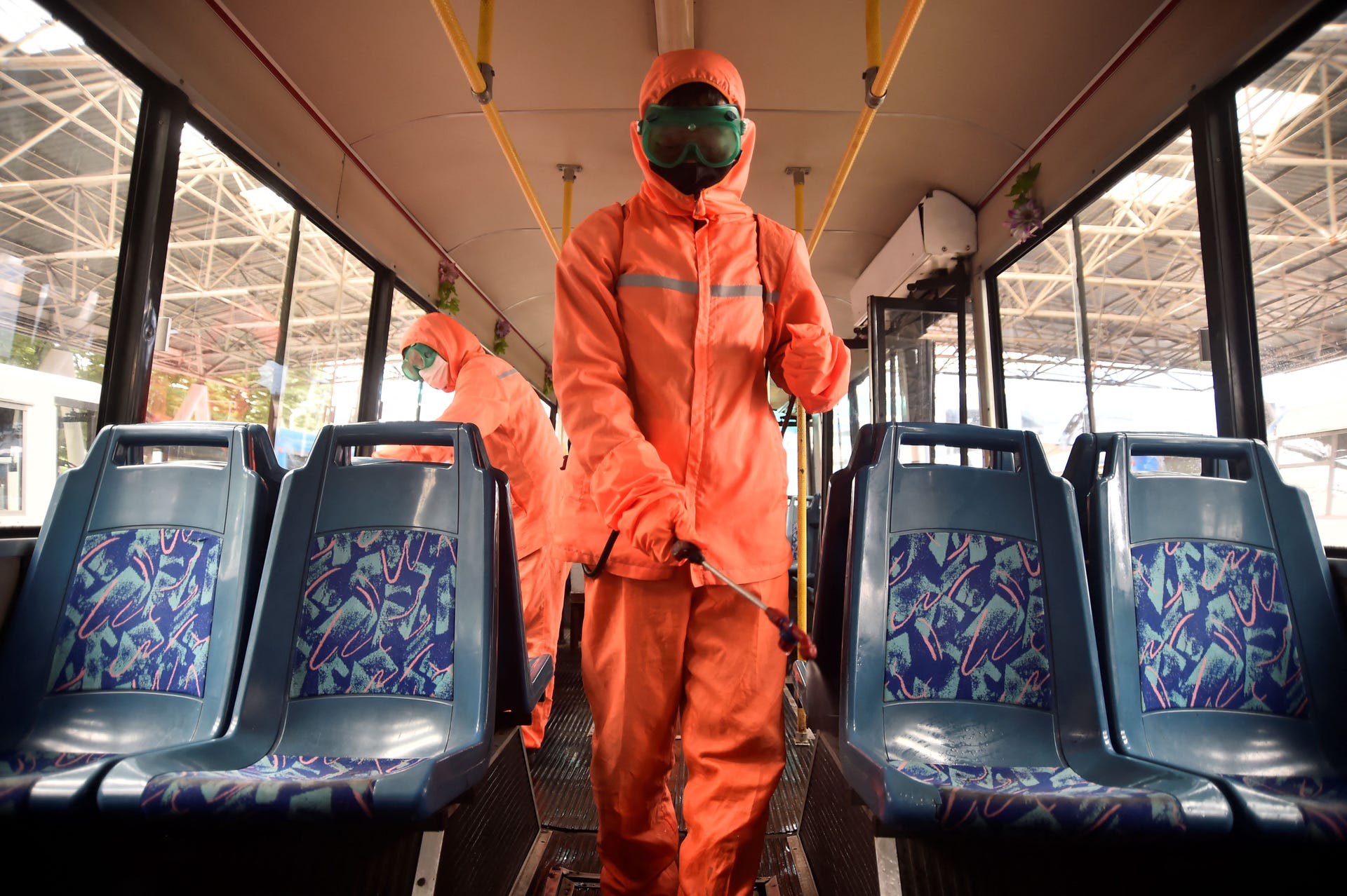 Health officials in protective gear disinfect a trolley bus in Pyongyang, North Korea, in June 2022