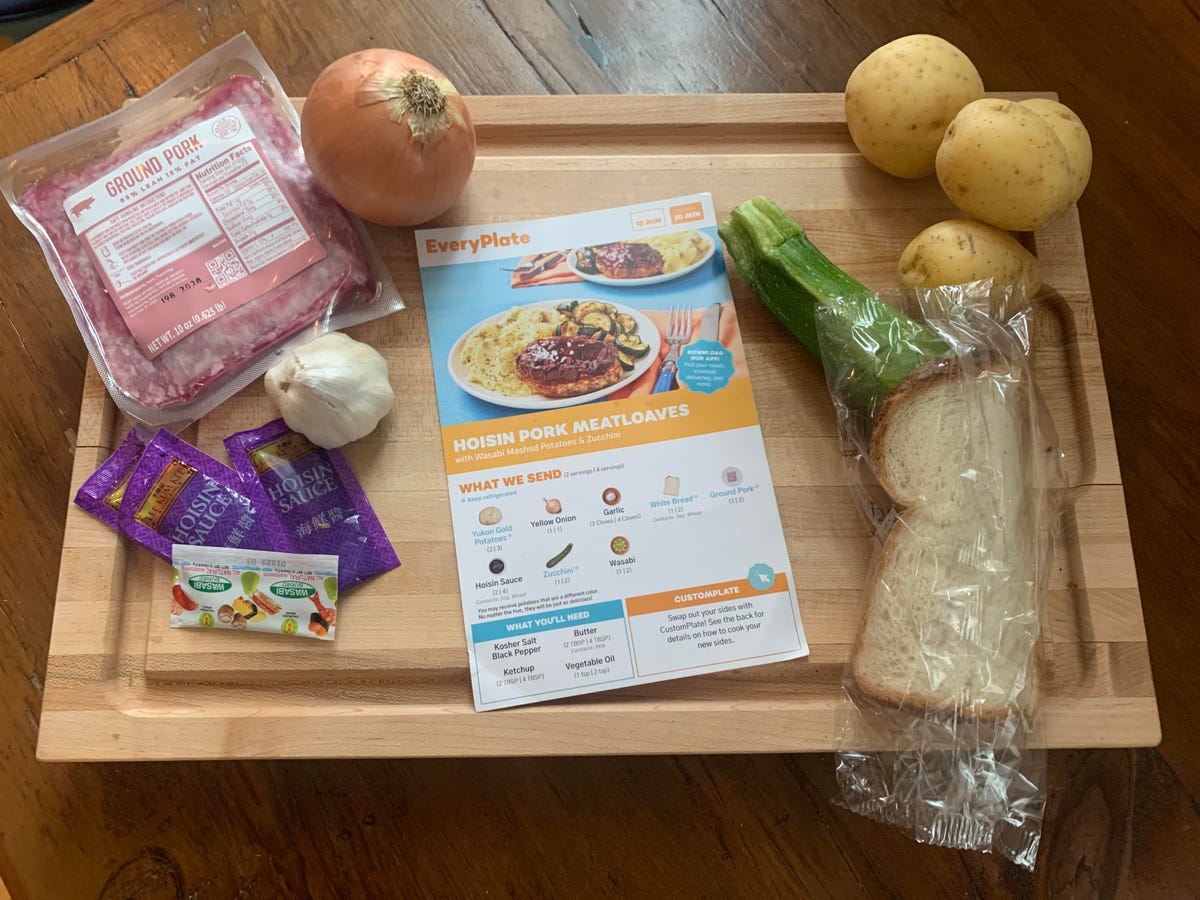 packaged ingredients for a meatloaf meal on cutting board with recipe card