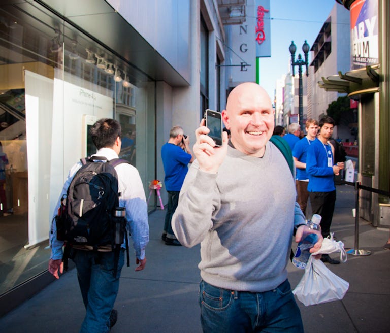 Duncan Fraser, the first in line at the downtown San Francisco store, strolls out after going in to buy the phone on launch day.