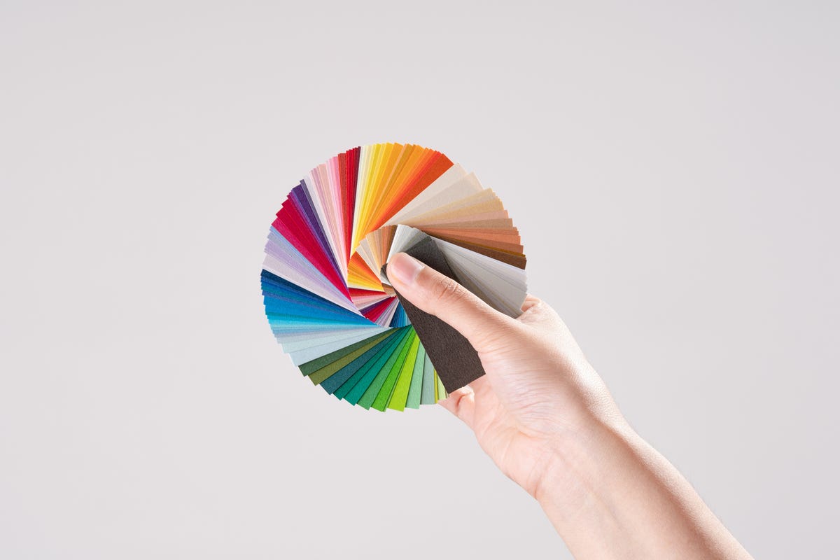 A hand holds out a color wheel.