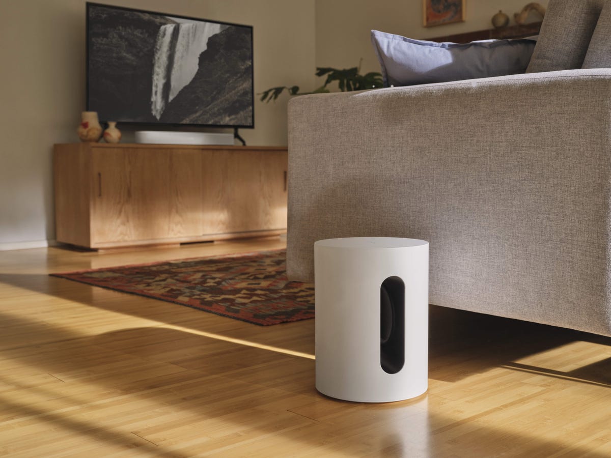 Sonos Sub Mini next to a couch in a living room