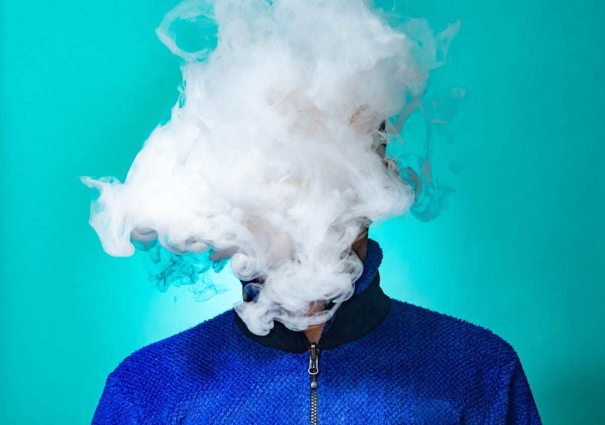 Person with a cloud of smoke in front of their face