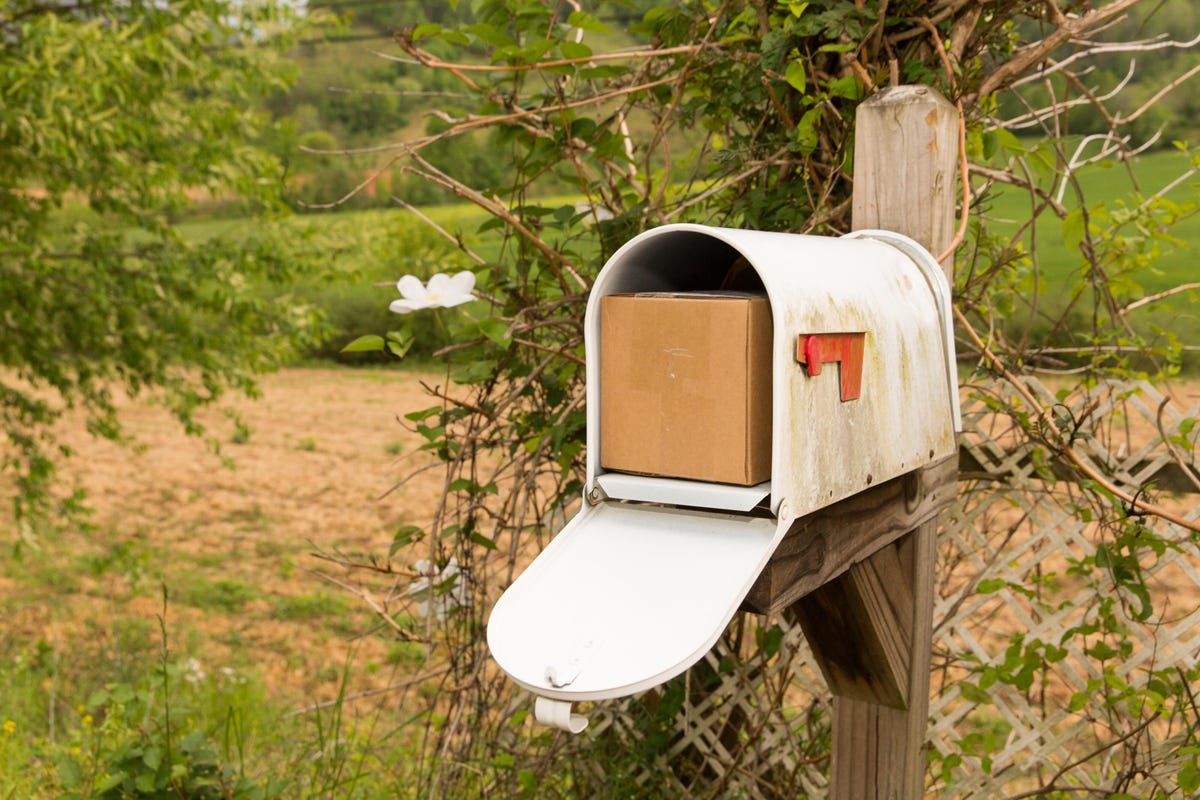 A rural mailbox with a package in it
