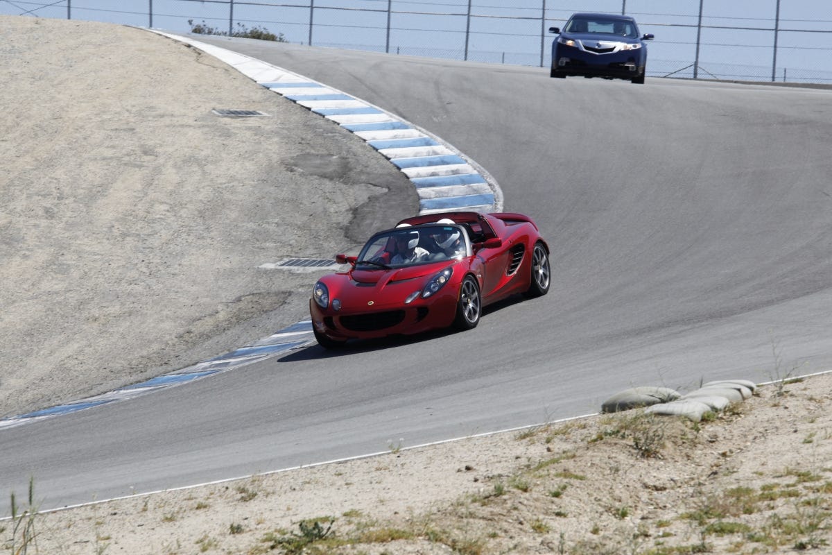 A Lotus and Acura on the track at Laguna Seca