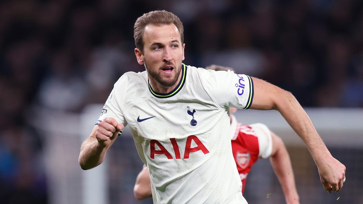 Tottenham Hotspur striker Harry Kane looking to his left while running forward