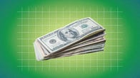 a stack of dollar bills in front of a green gradient background