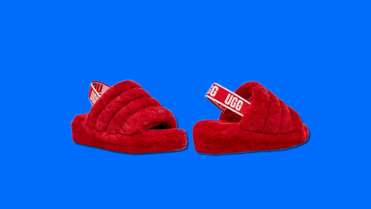 A pair of fuzzy red UGG slingback slides next to each other