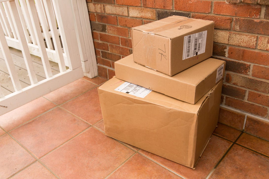 Three stacked boxes sitting on porch