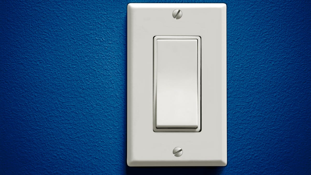 A light switch and a blue wall