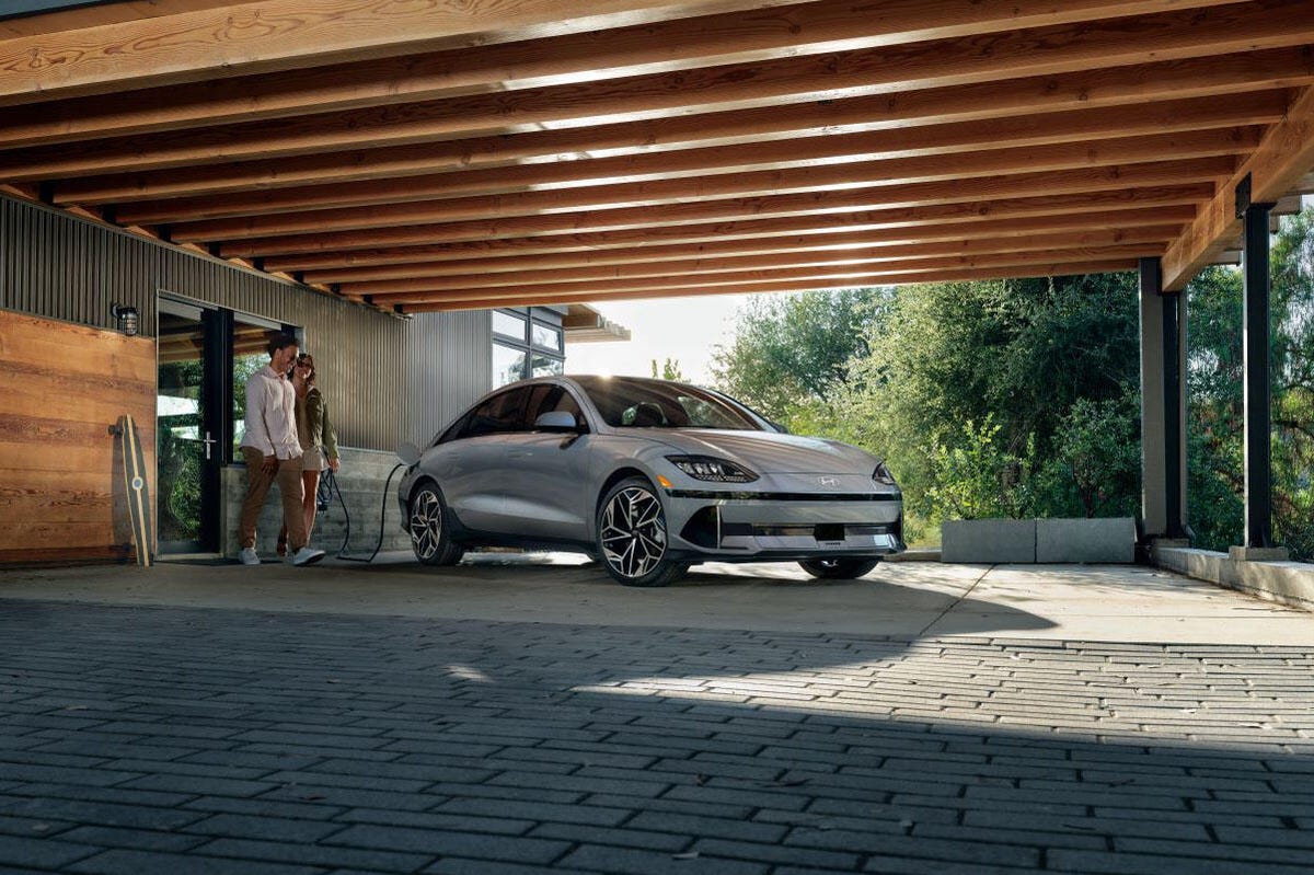 Hyundai Ioniq 6 EV charging under an architecturally interesting wooden roof