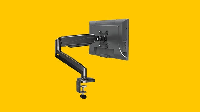 Close up of the MountUp Single Monitor Desk Mount on a yellow background