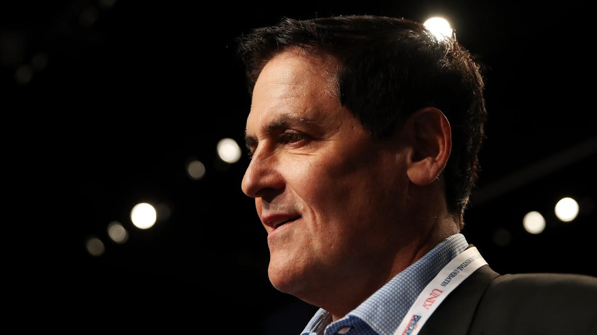 An image of Mark Cuban with a blurred dark background.
