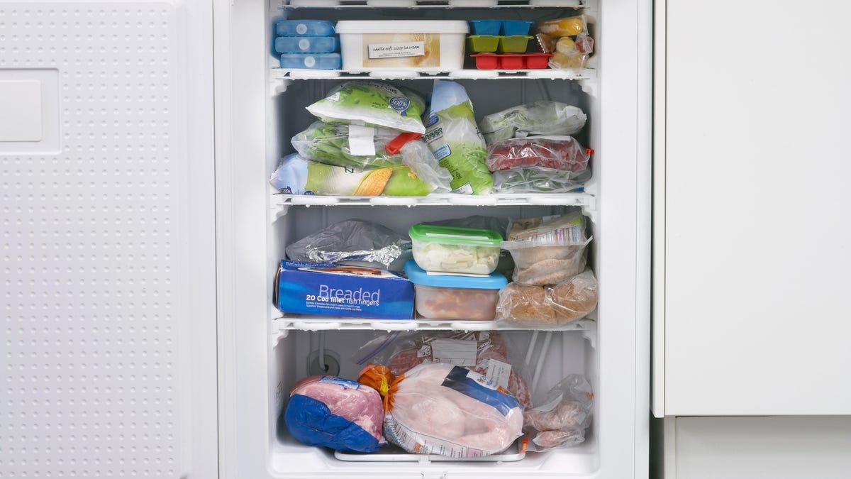 Frozen food in full freezer with open door
