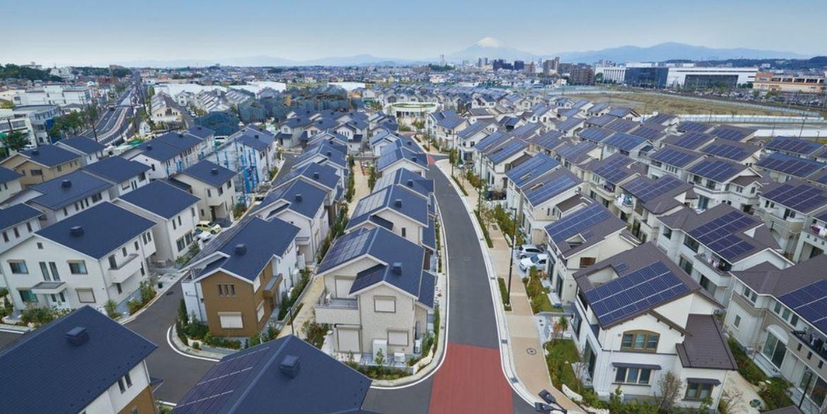 Rows of houses with photovoltaic panels on their roofs. 