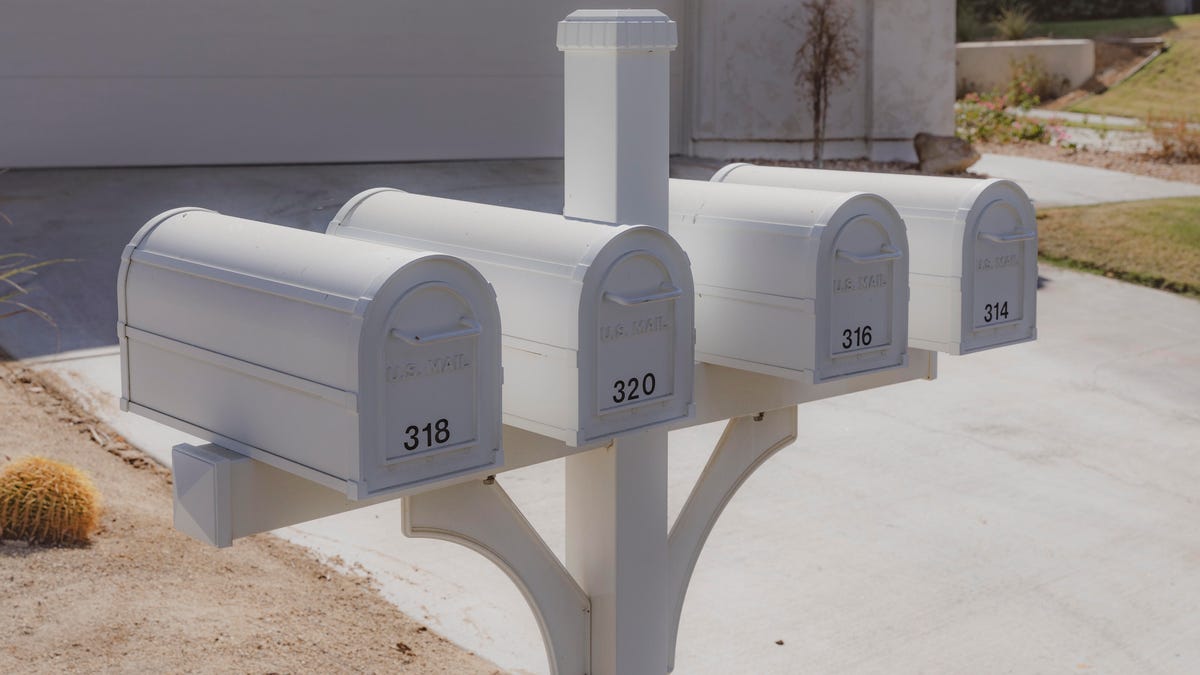 Four silver mailboxes in a row