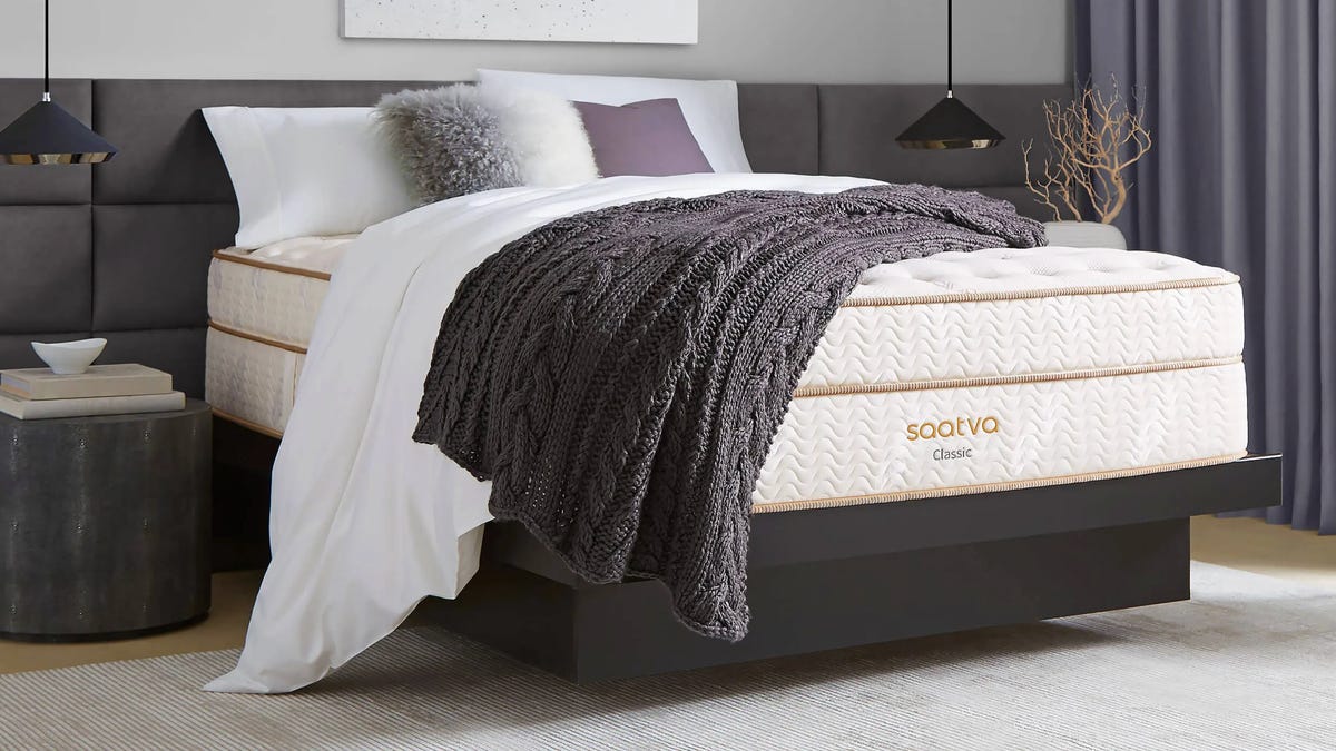 A Saatva Classic in a bedroom with a dark brown throw blanket.